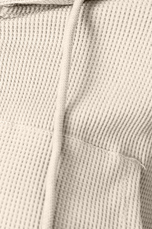 Waffle knit cropped zip hoodie in ivory with drawstring and pocket detail.