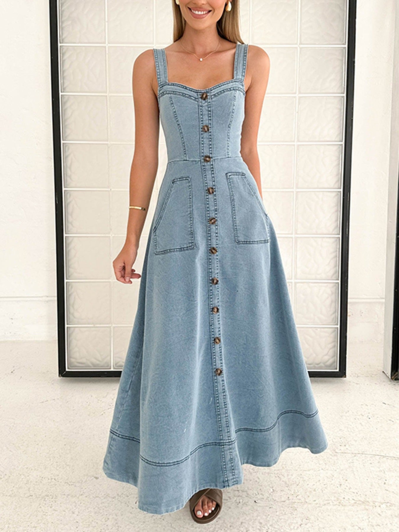 Light wash denim A-line midi dress with button front, square neckline, and patch pockets.