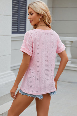 Pink perforated pocket tee with rolled sleeves and a casual fit.
