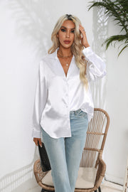 White glossy satin button-down blouse with a relaxed fit, styled with jeans.