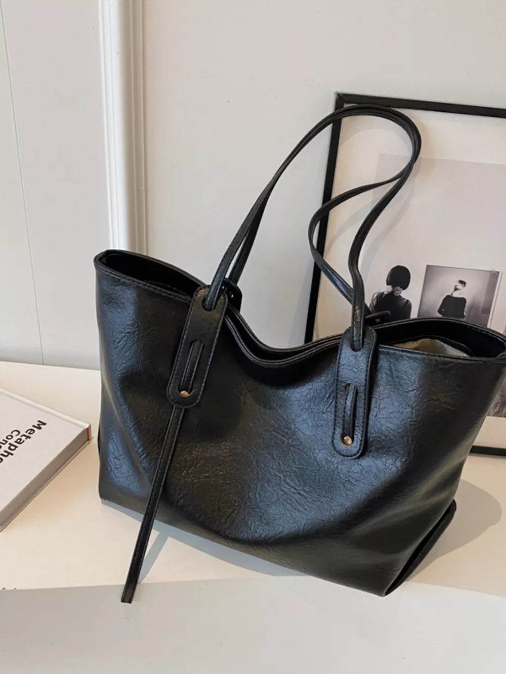 Elegant large black pu leather shoulder bag with double straps and a relaxed silhouette.