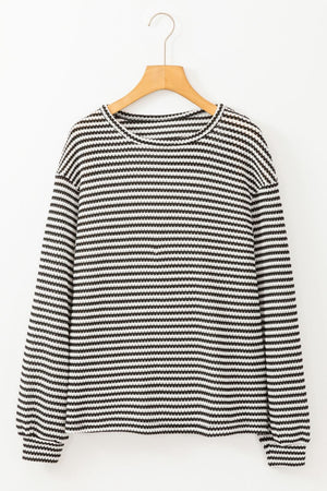 Textured stripe balloon sleeve top in black and white with a crew neck.