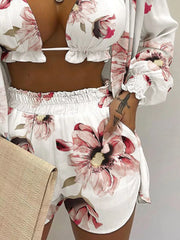 Floral print two-piece outfit set with ruffled trim and smocked cuffs, ivory with pink flowers.