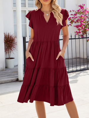 Burgundy ruffled midi dress with notched V-neck, elastic waist, and pockets.