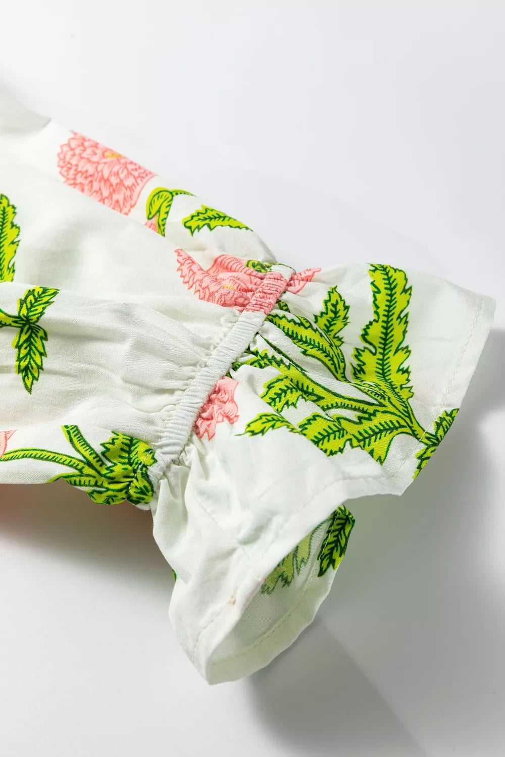 White cotton blouse with pink floral print and ruffled sleeves