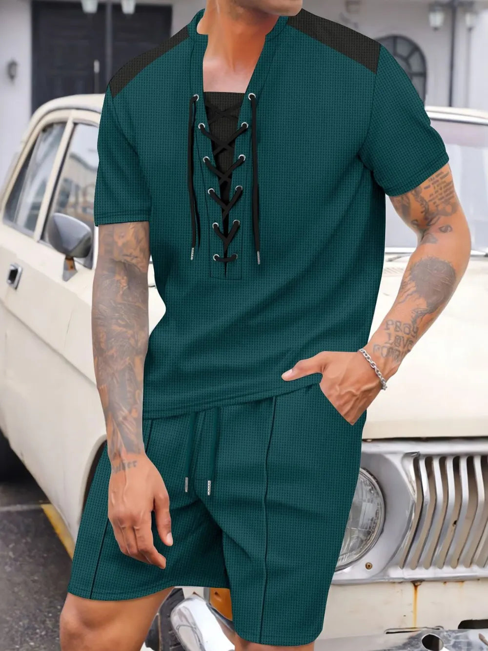 Dark green waffle knit lace-up lounge set with short sleeves and drawstring shorts.