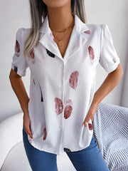 White feather print collared puff sleeve blouse with button front.