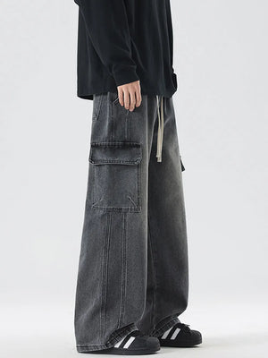 Oversized dark gray denim cargo jeans with drawstring waist and large front pockets.