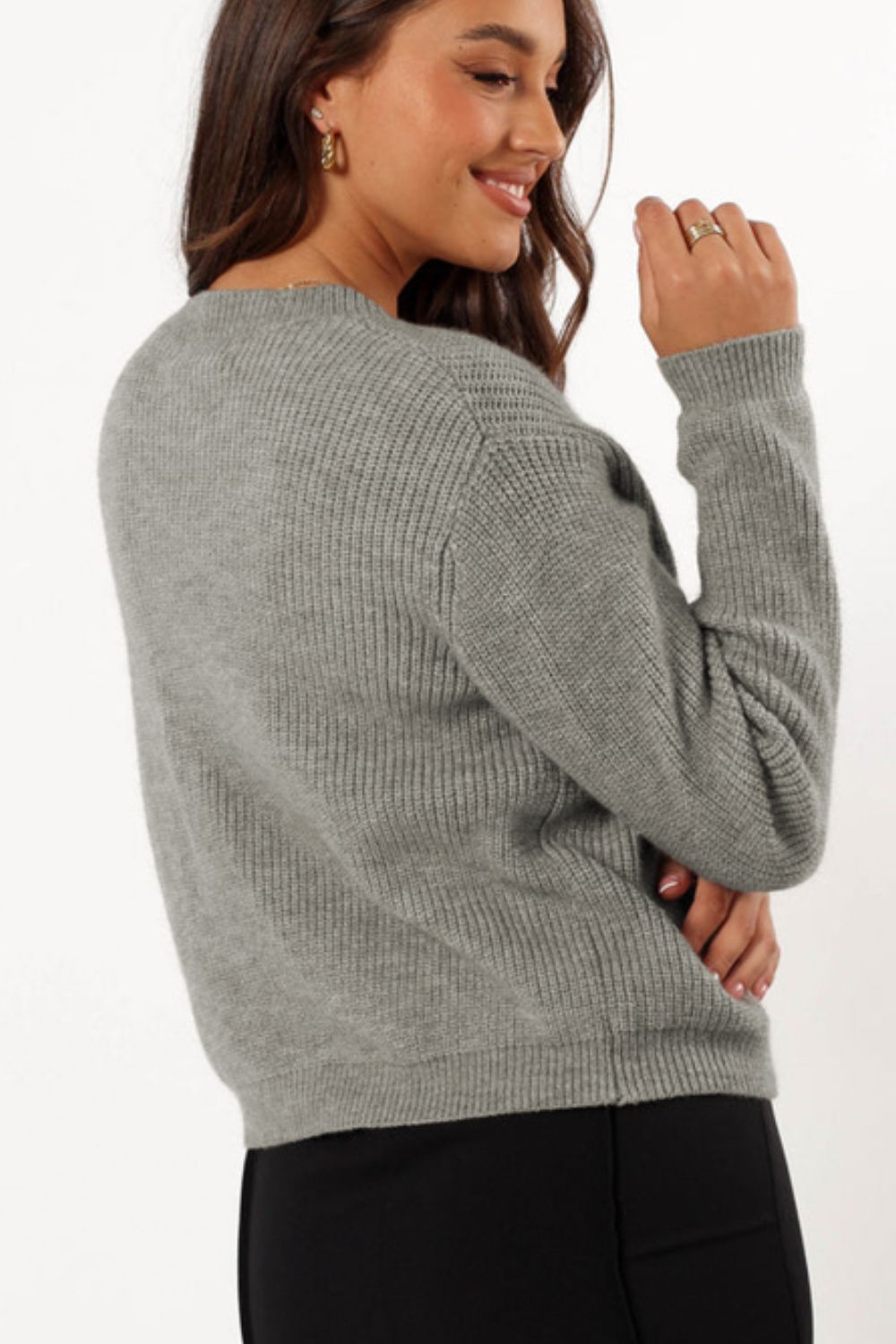 Gray ribbed knit cardigan with a crew neck and long sleeves, styled casually.