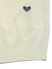 Cream acrylic sweater with scattered dark heart intarsia detail and ribbed hem.