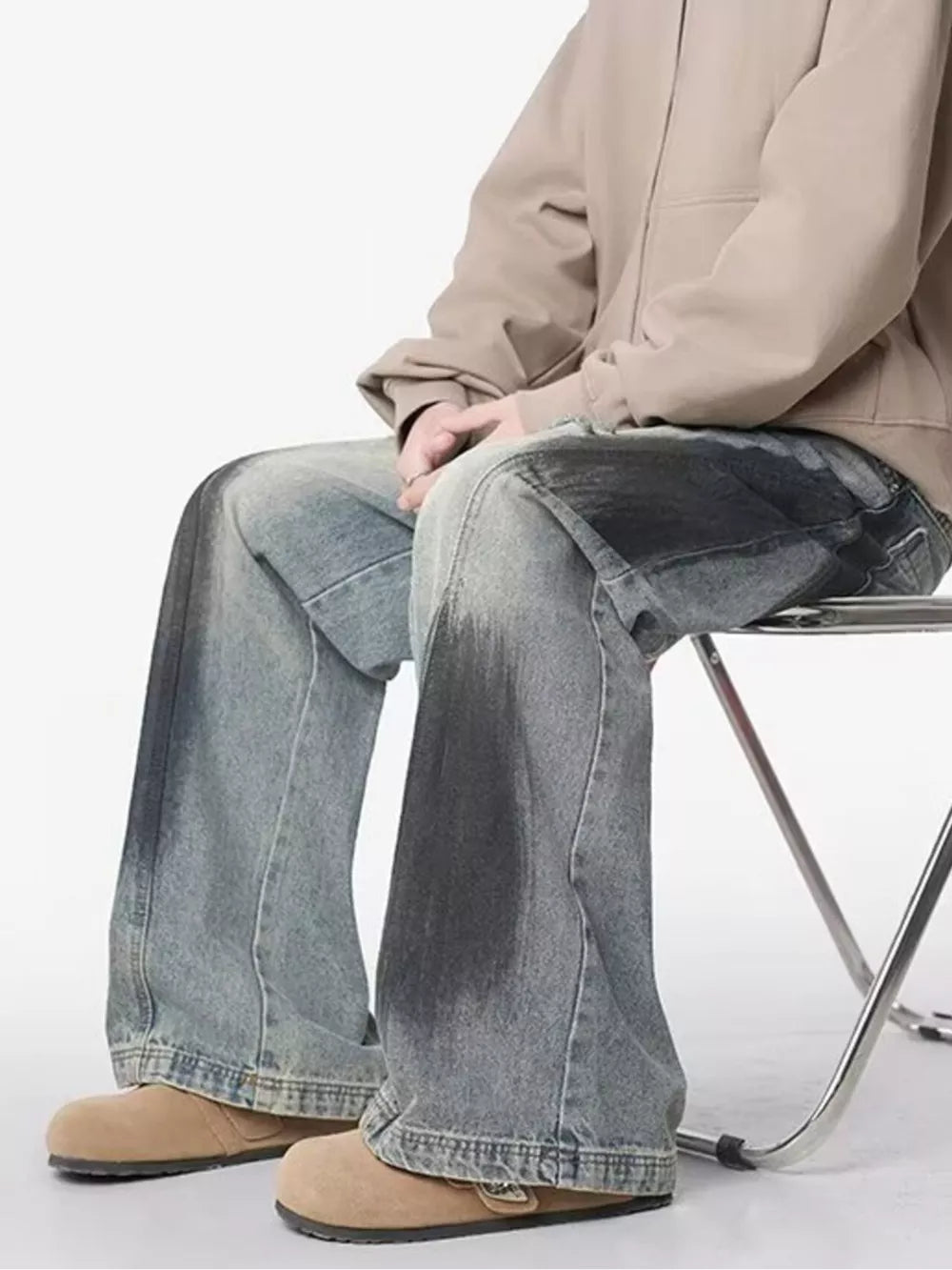 Distressed wide-leg jeans in light wash denim with dark wash accents and a belted detail.