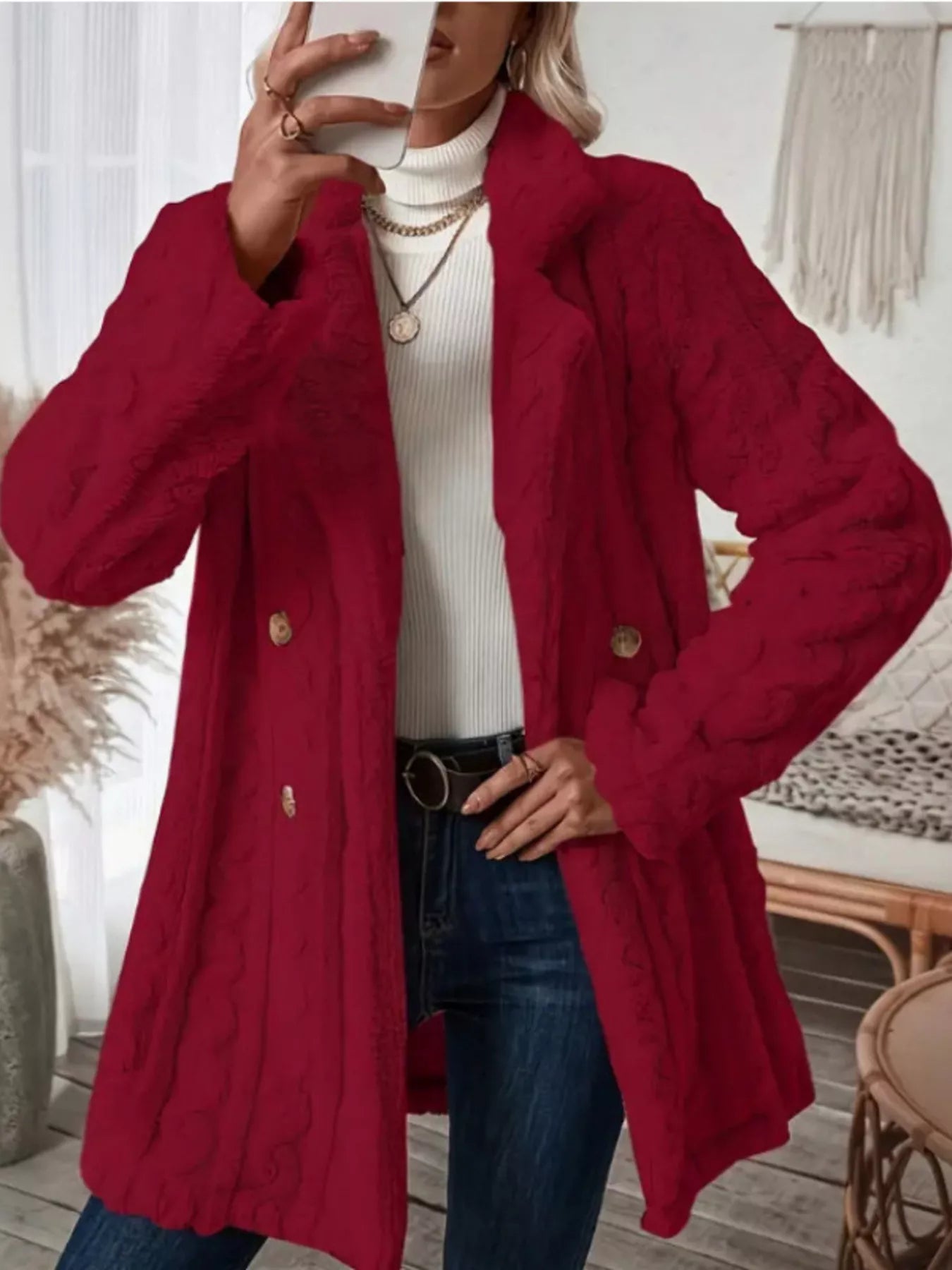 Red faux shearling double-breasted overcoat with cable knit texture and gold buttons.