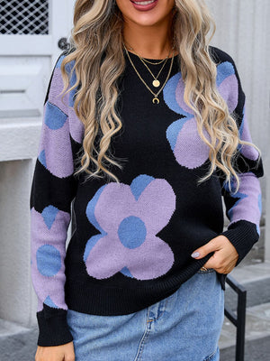 Black oversized knit sweater with large floral print in lavender and blue.