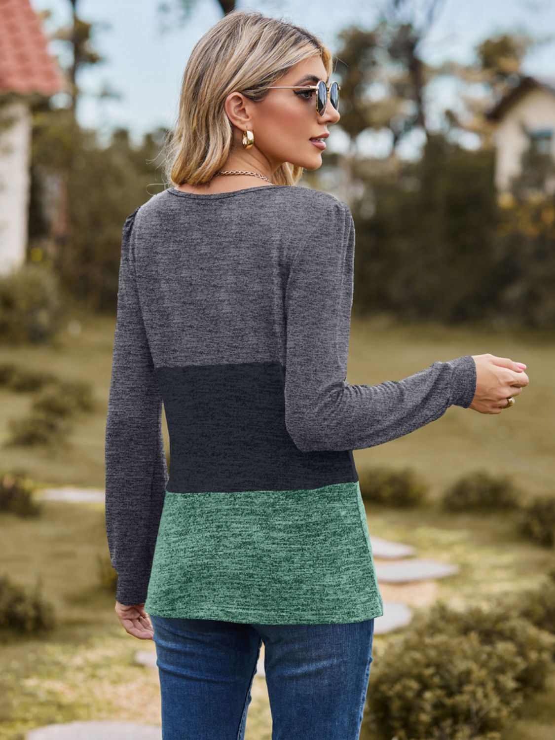 Long sleeve colorblock blouse with gray, black, and gum leaf panels and a square neckline.