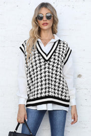 Houndstooth knit v-neck vest with black and white pattern and striped trim.