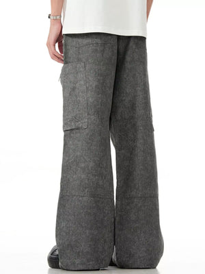 Grey wide-leg cargo pants with multiple pockets and a relaxed fit.
