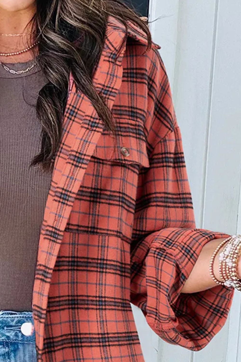 Oversized orange-red plaid shacket with a patch pocket and button detail.