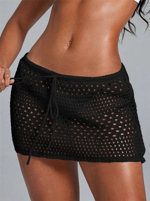 Black crochet mini skirt with openwork pattern and drawstring waist.
