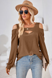 Brown geometric cutout shoulder top with a v-neck and long sleeves.