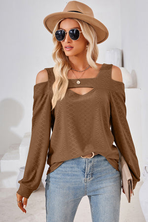 Brown geometric cutout shoulder top with a v-neck and long sleeves.