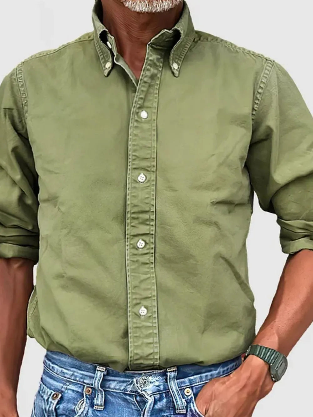 Olive green Oxford button-down shirt with relaxed fit and button collar, paired with blue jeans.