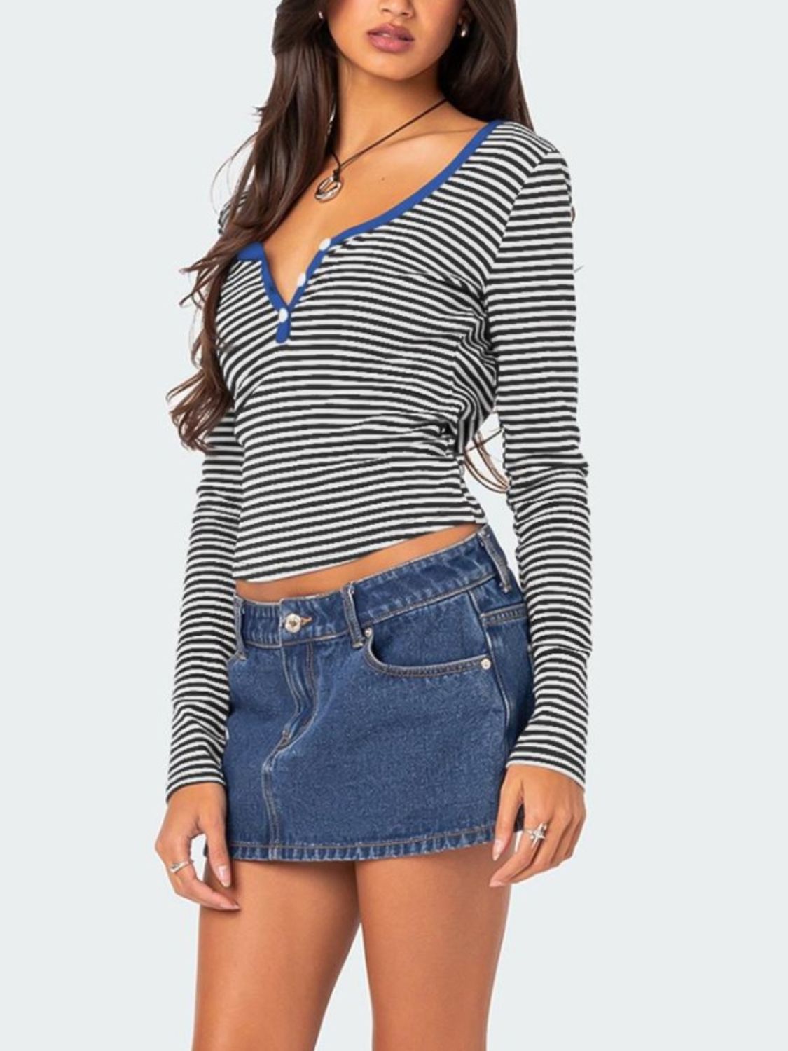 Striped long sleeve henley shirt with contrast blue collar and button detail.