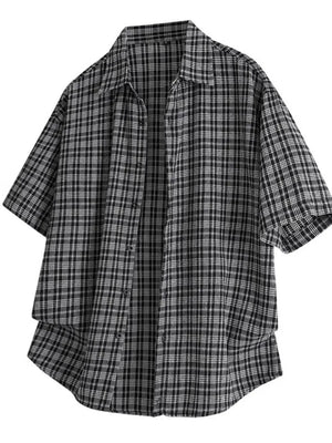 Black oversized plaid button-front shirt with short sleeves.