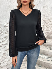 Black V-neck blouse with sheer dot puff sleeves