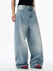 Men's light blue washed denim wide leg jeans with vertical seam details.