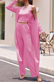 Ribbed knit duster and lounge set in fuchsia pink, featuring a cropped tank with ruched sides and wide-leg pants.