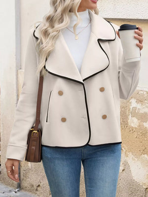 Beige double-breasted bolero jacket with black contrast trim and gold buttons.