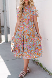 Floral smocked bodice tiered midi dress with short sleeves and a-line cut.