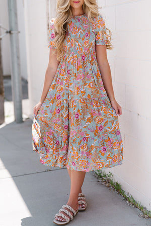 Floral smocked bodice tiered midi dress with short sleeves and a-line cut.