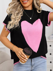 Black acrylic knit top with pink heart graphic and ribbed accents.