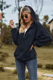Dark Blue textured cable knit zip-up hoodie with drawstring hood and pockets.