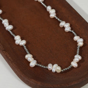 Silver necklace with irregular pearl clusters and small metallic beads