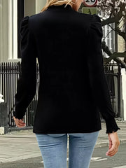 Black gathered mock neck maternity top with puff sleeves and ruffled cuffs.