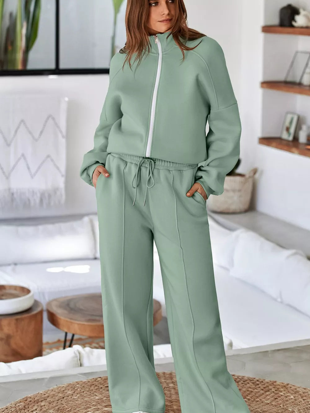 Sage cotton zip-up jacket and drawstring pants set with white zipper detail.