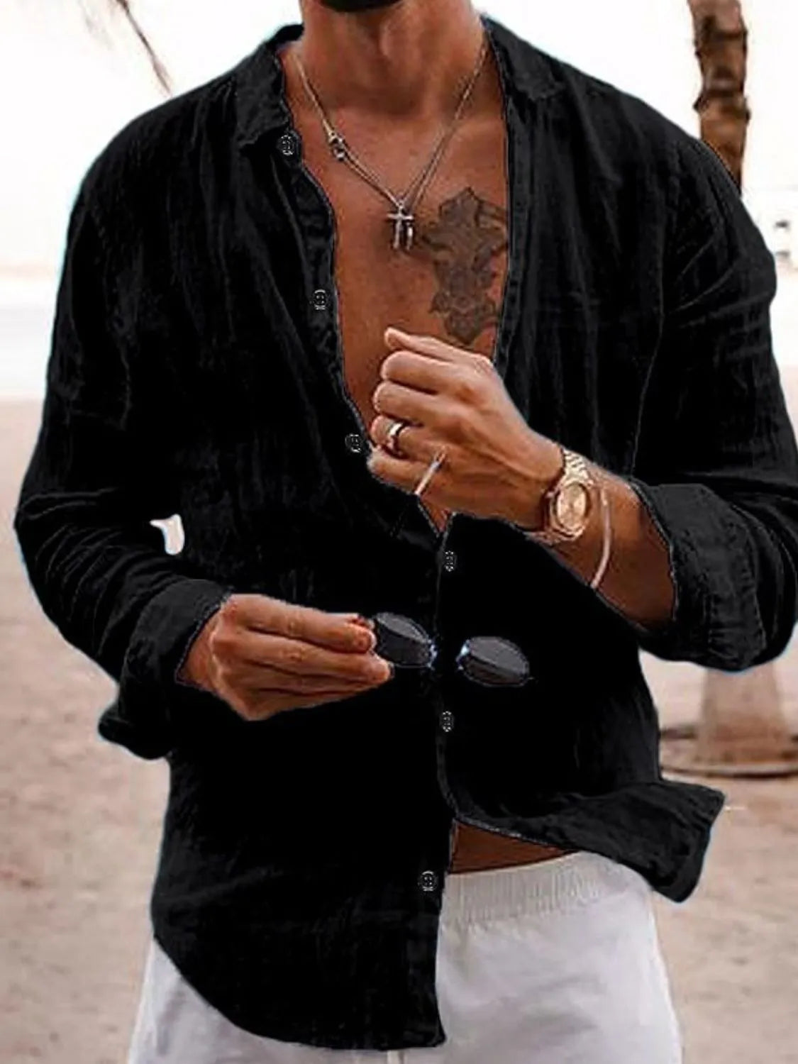 Black linen button-front shirt with relaxed fit and long sleeves.