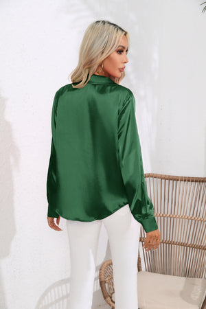 Glossy satin button-down blouse in dark green, shown from the back.