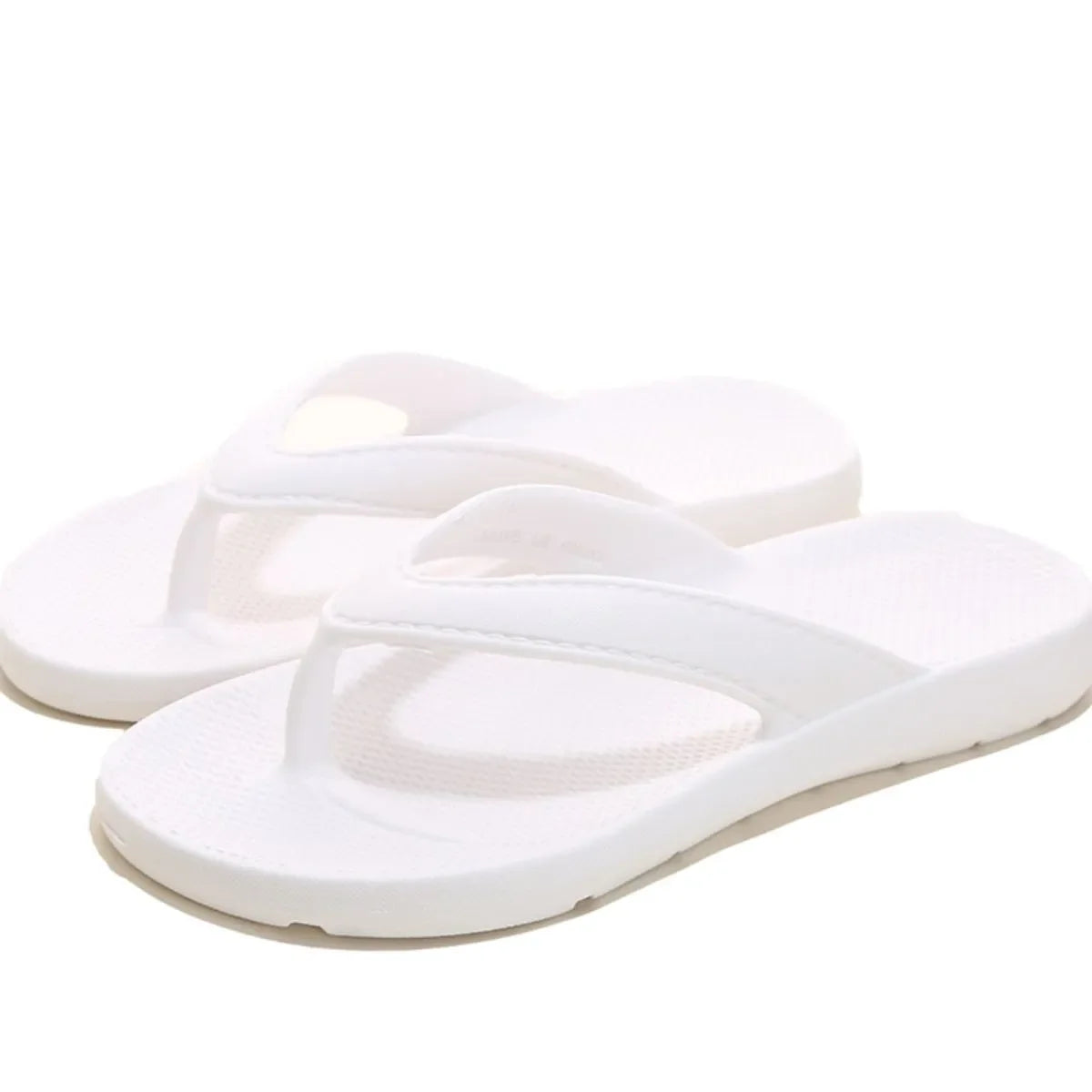 White textured rubber thong sandals with a casual beach style.