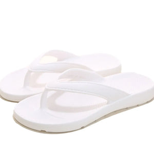 White textured rubber thong sandals with a casual beach style.