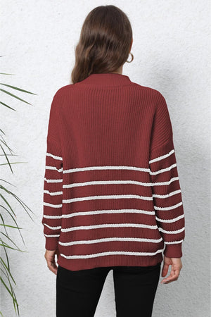 Burgundy ribbed knit sweater with white horizontal stripes and mock neck.
