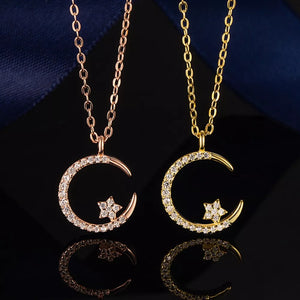 Celestial crescent moon and star necklace in gold and rose gold with pave crystals.