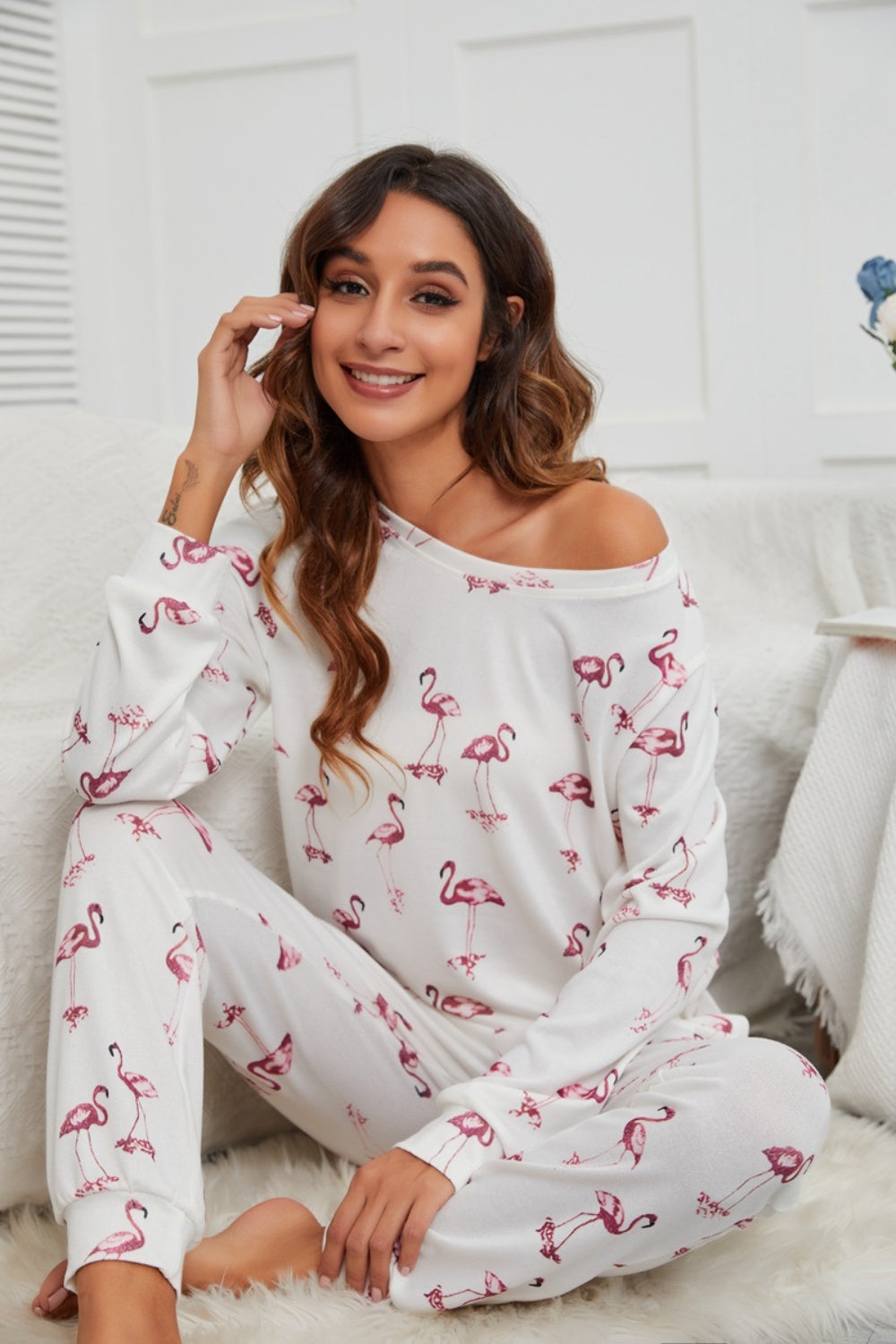 White flamingo print off-shoulder loungewear set with long sleeves and pants.