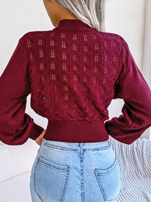 Burgundy openwork knit sweater with puff sleeves and mock neck, cropped length.