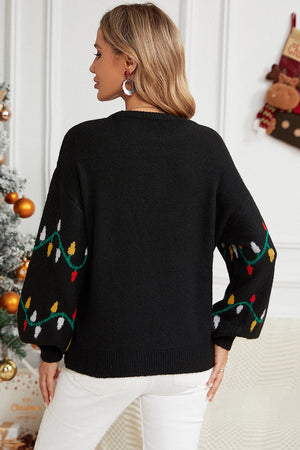 Black acrylic sweater with colorful Christmas lights pattern on sleeves.