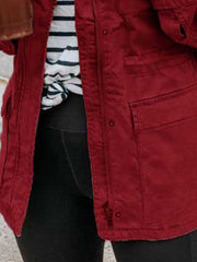 Rust utility jacket with zip and button closure, chest and hip pockets.