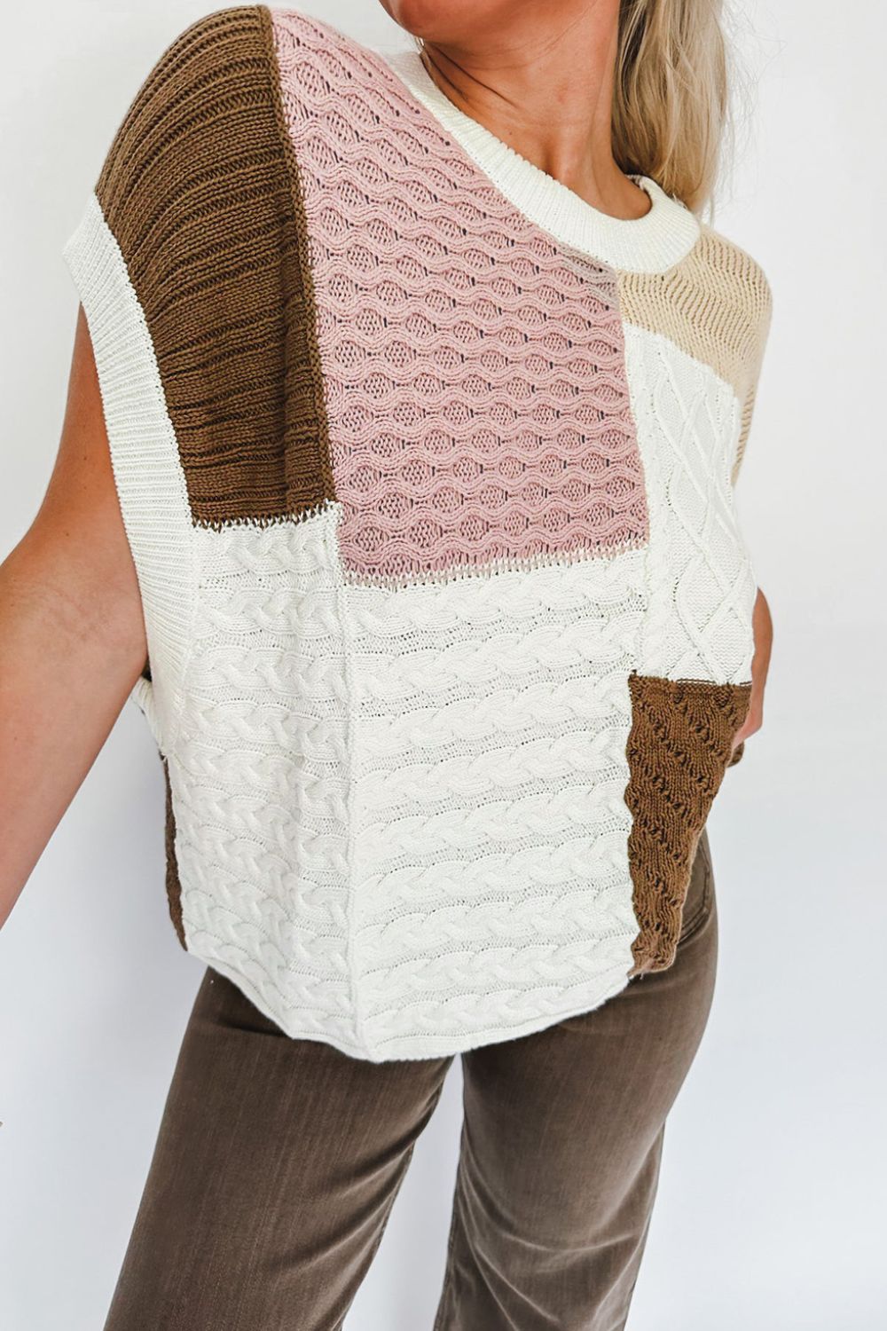 Patchwork cable knit tank top in dusty pink, white, and brown with varied knit textures.
