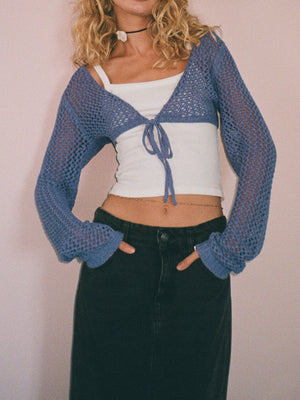 Dusty blue crochet tie-front bolero shrug with long sleeves and open knit detail.